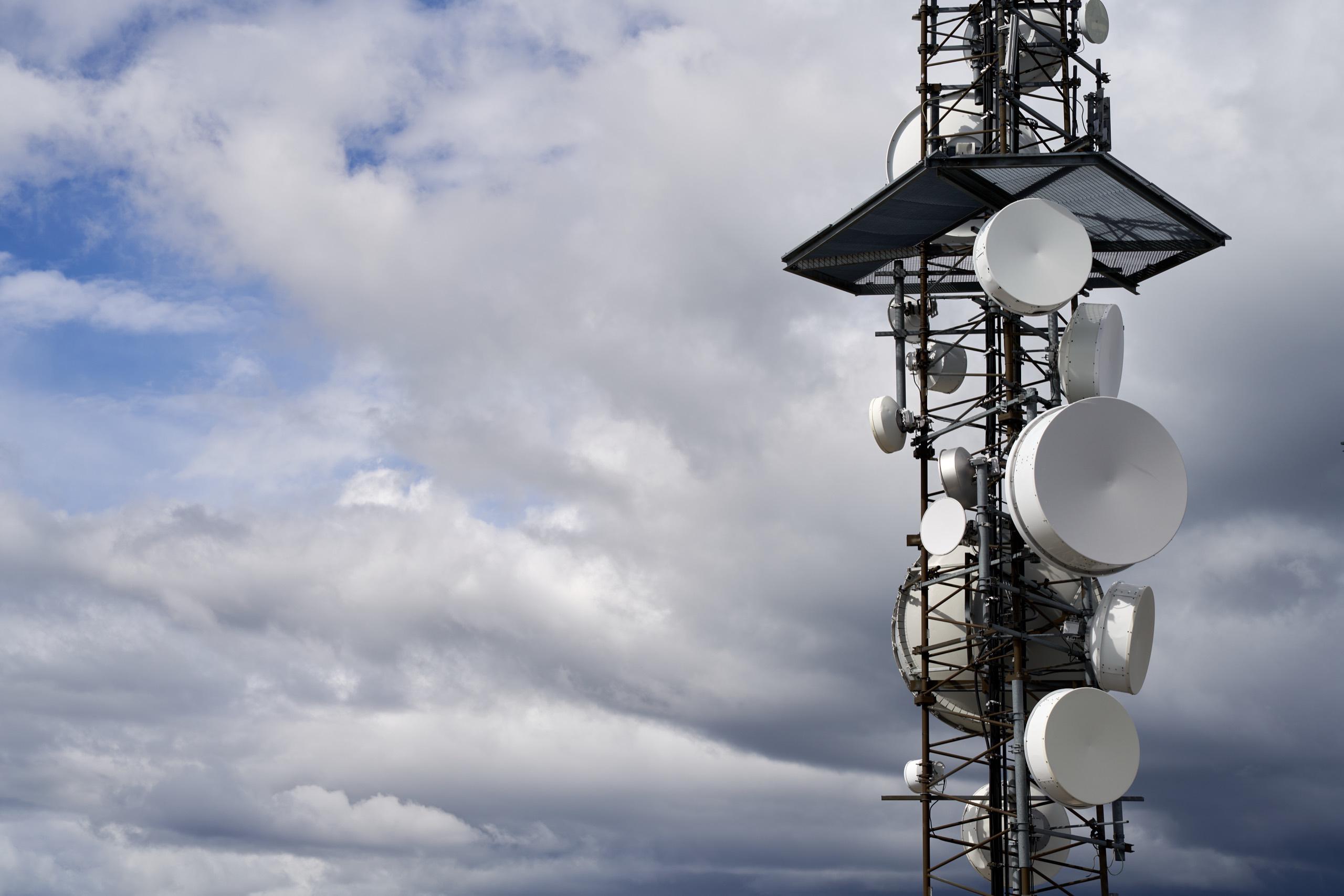 Telecommunications towers under a cloudy sky